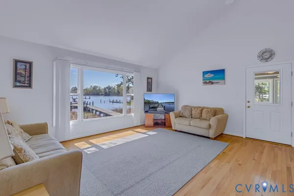 a living room with furniture and a dining table with kitchen view