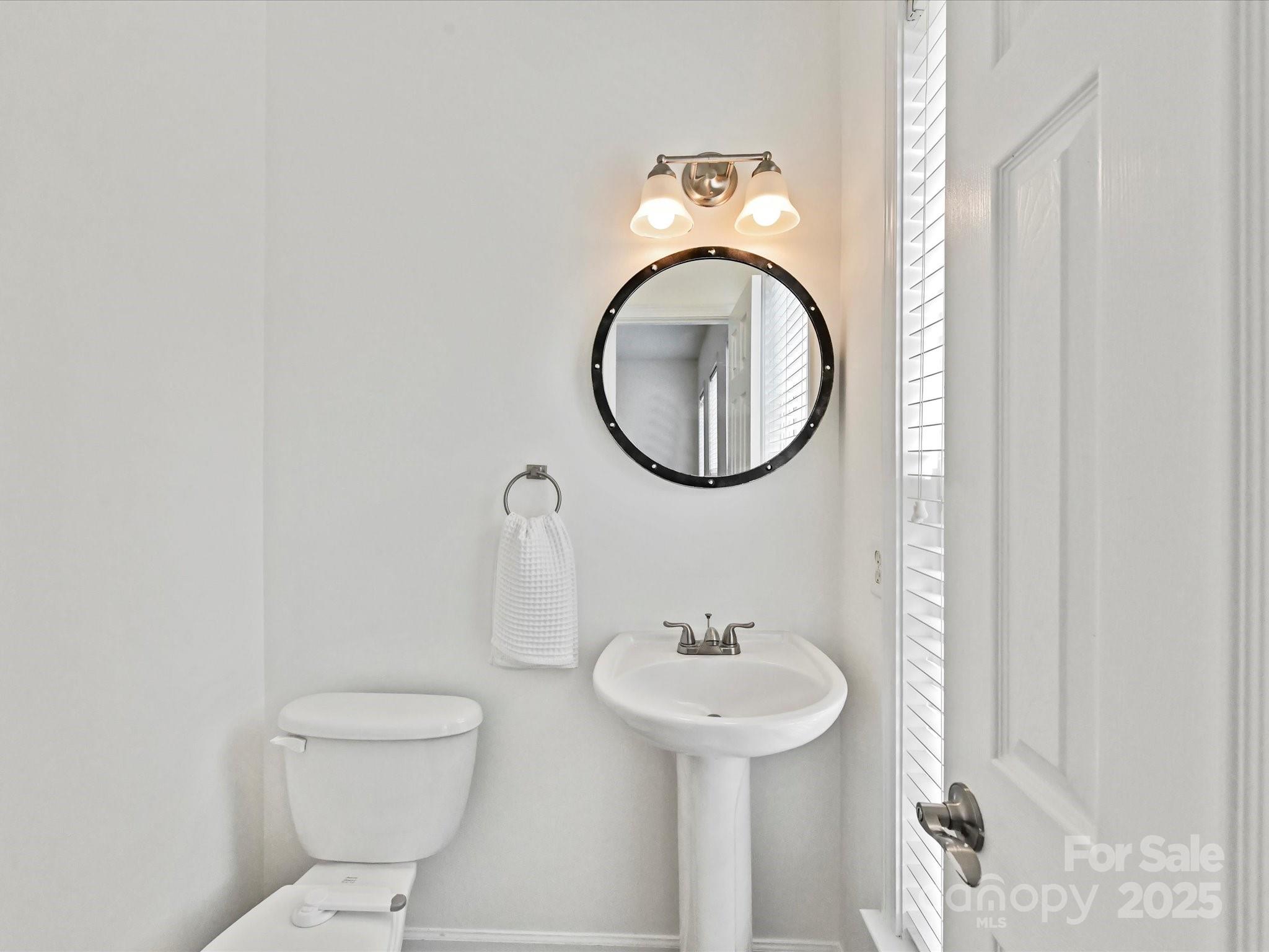 14130 Fitzroy Lane Charlotte, NC 28277 - Photo 14 of 24 a bathroom with a toilet sink and mirror