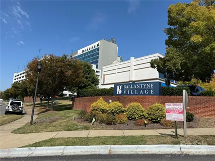 a sign board with buildings in the background