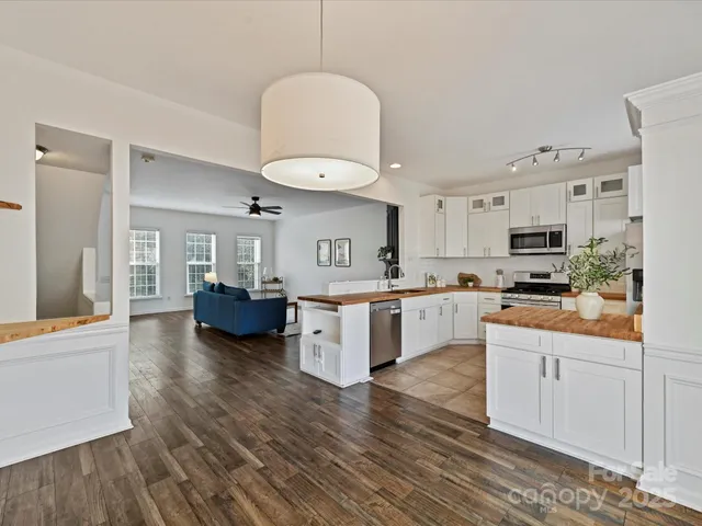 a kitchen with white cabinets and counter space