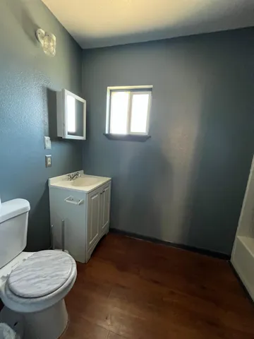 a bathroom with a toilet sink and mirror