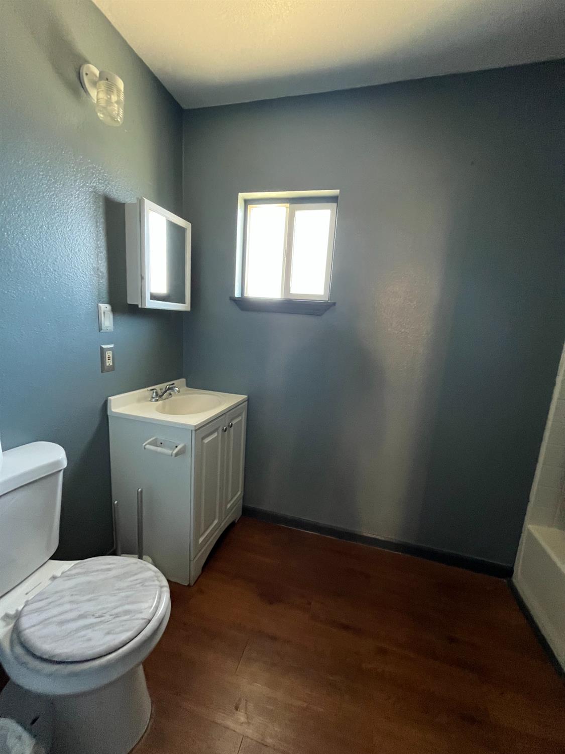 2111 Hackett Road Ceres, CA 95307 - Photo 3 of 9 a bathroom with a toilet sink and mirror