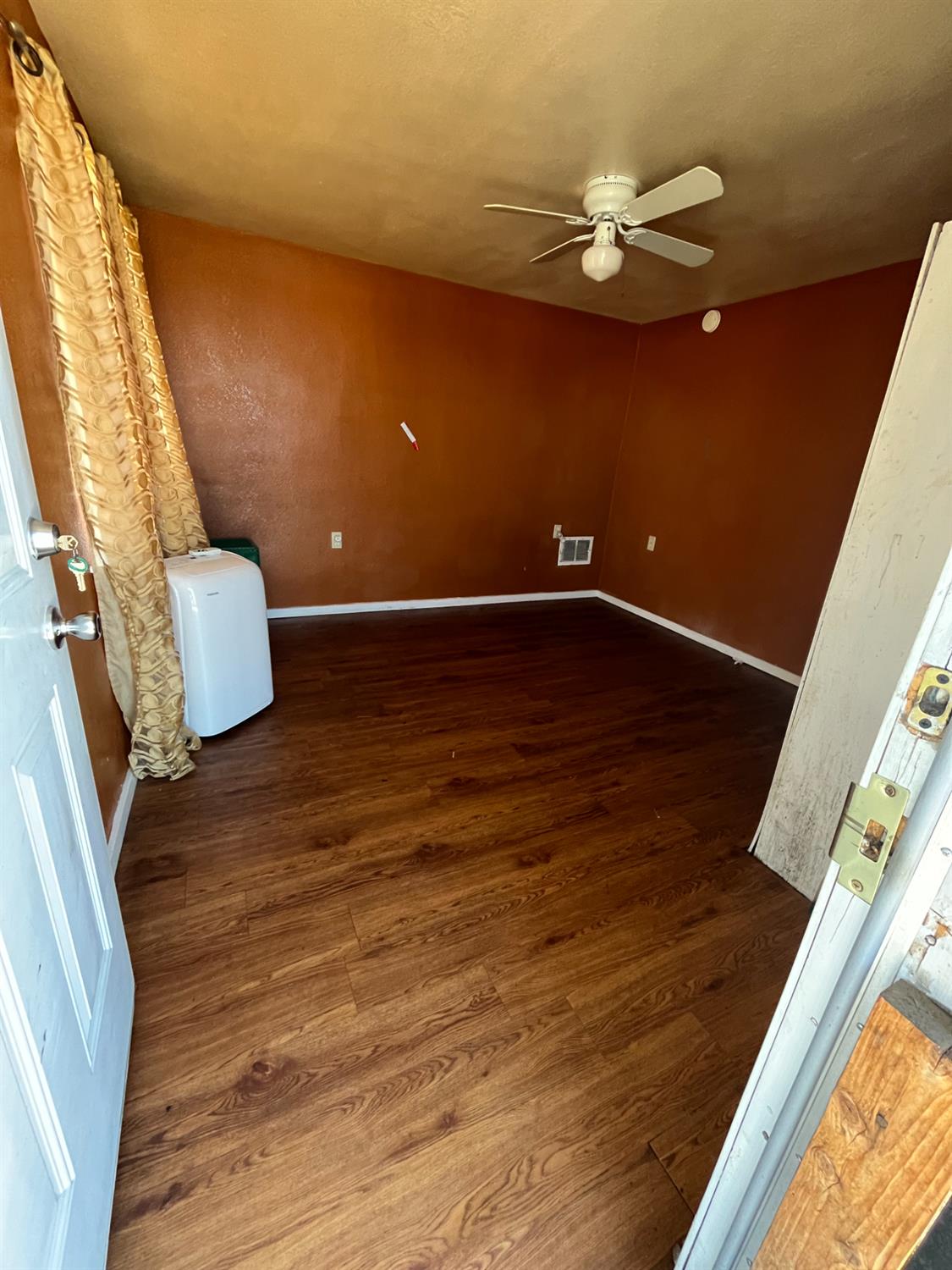 2111 Hackett Road Ceres, CA 95307 - Photo 6 of 9 a view of water heater room with wooden floor
