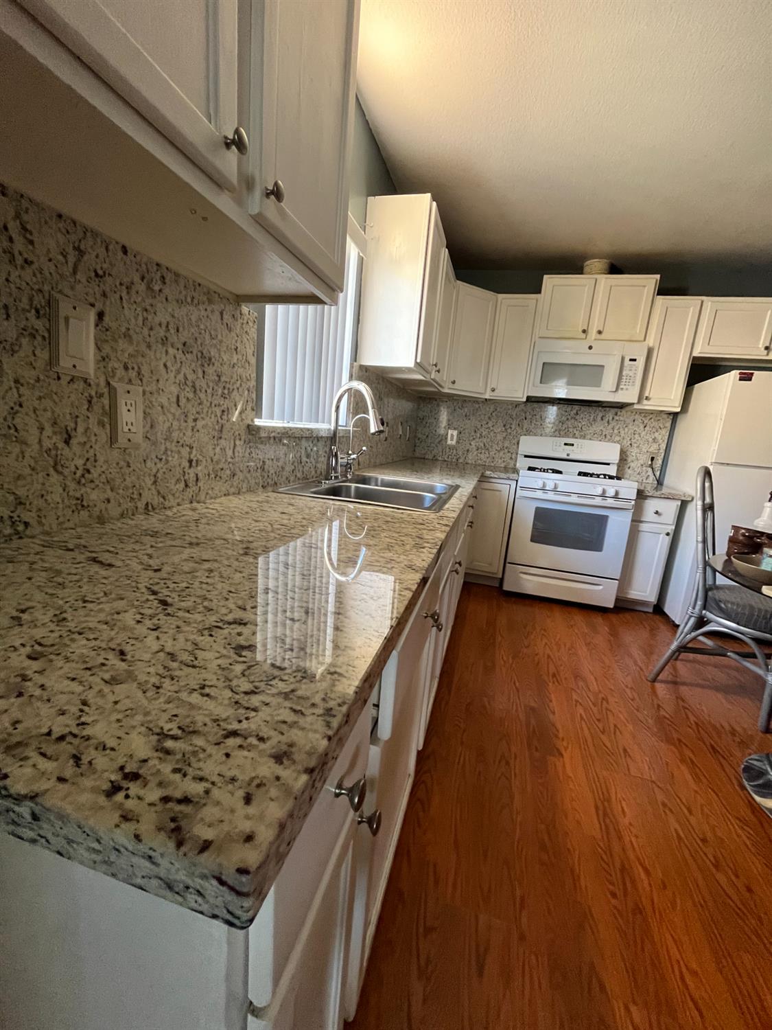 2111 Hackett Road Ceres, CA 95307 - Photo 8 of 9 a kitchen with sink a stove and cabinets