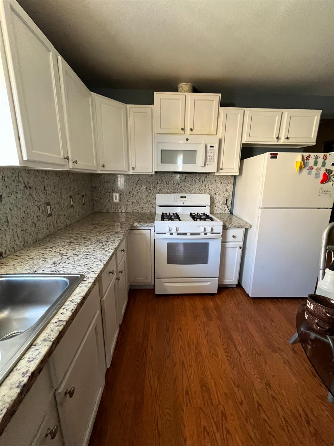2111 Hackett Road Ceres, CA 95307 - Photo 9 of 9 a kitchen with a refrigerator sink stove and cabinets