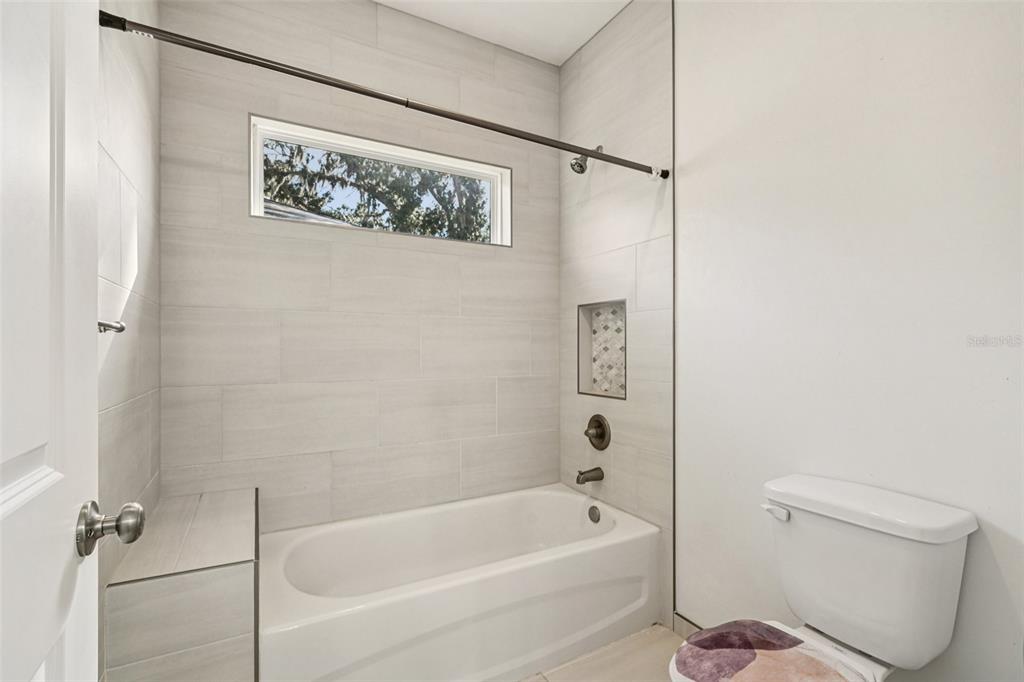 6657 Southwest 15 Place Gainesville, FL 32607 - Photo 15 of 23 a bathroom with a toilet and a bathtub