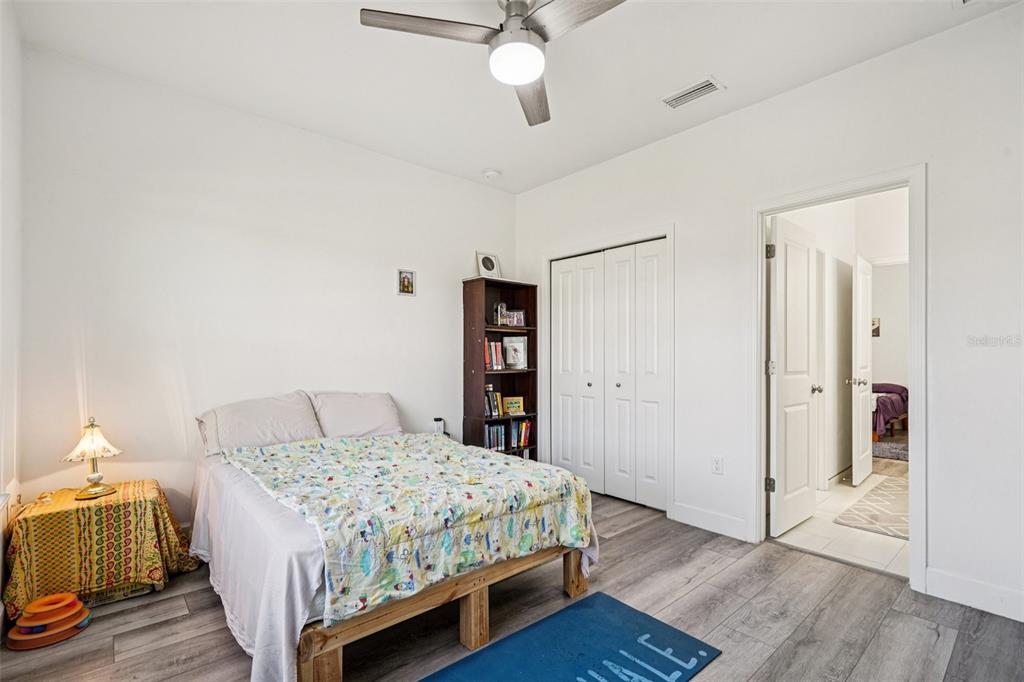6657 Southwest 15 Place Gainesville, FL 32607 - Photo 16 of 23 a bedroom with a bed and wooden floor
