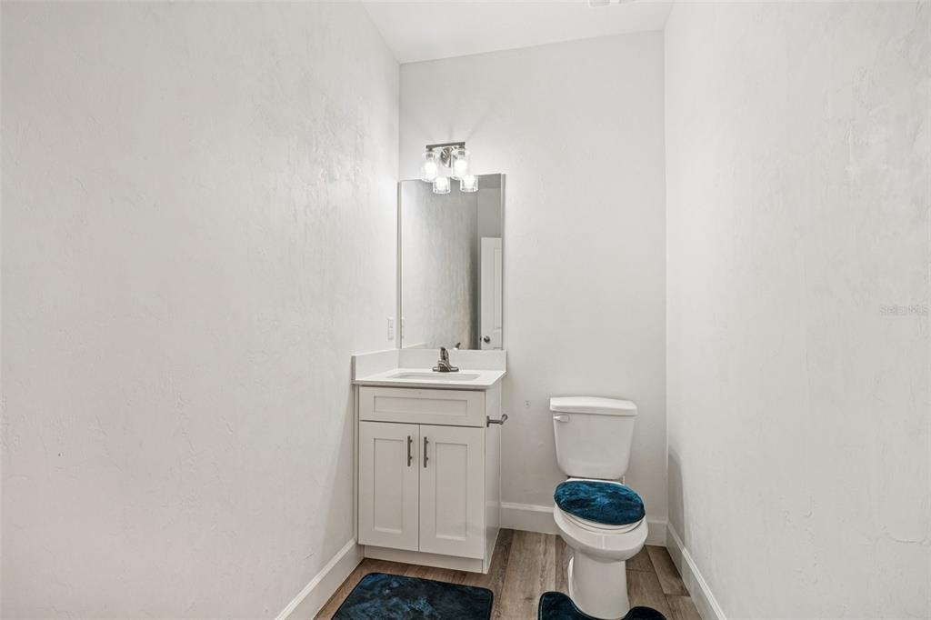 6657 Southwest 15 Place Gainesville, FL 32607 - Photo 18 of 23 a bathroom with a toilet a sink and mirror