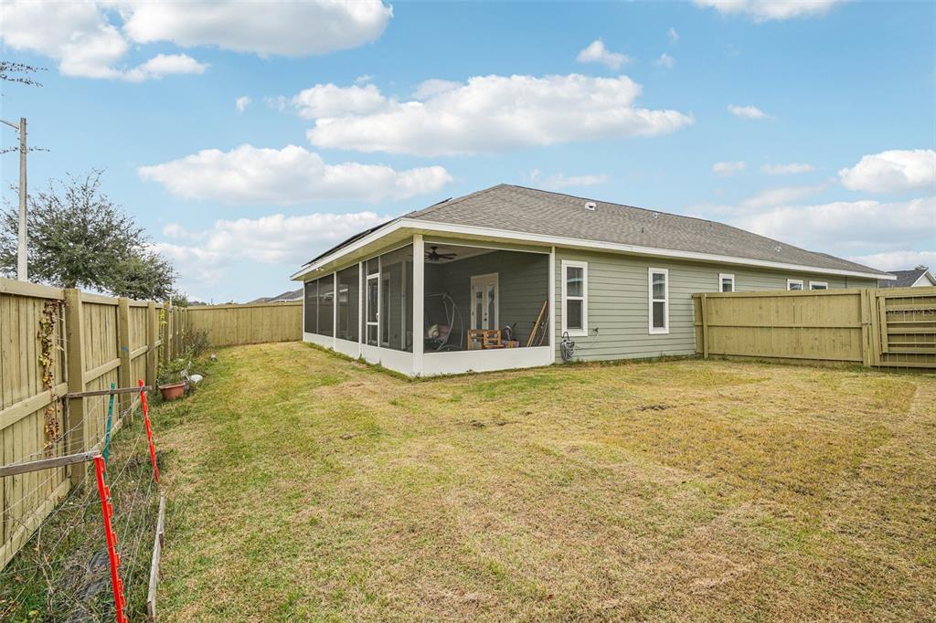 6657 Southwest 15 Place Gainesville, FL 32607 - Photo 21 of 23 a view of a house with a wooden fence
