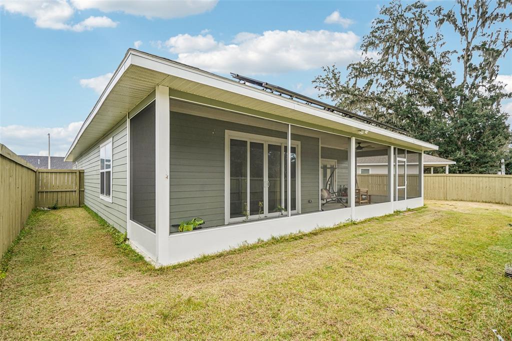 6657 Southwest 15 Place Gainesville, FL 32607 - Photo 22 of 23 a view of backyard with large trees and a small yard