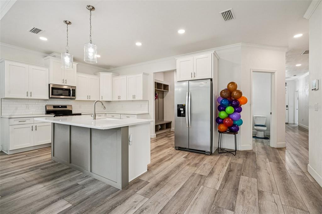 6657 Southwest 15 Place Gainesville, FL 32607 - Photo 4 of 23 a kitchen with stainless steel appliances a refrigerator and a wooden floor