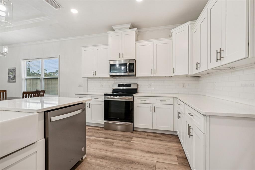 6657 Southwest 15 Place Gainesville, FL 32607 - Photo 5 of 23 a kitchen with granite countertop a sink and a stove top oven