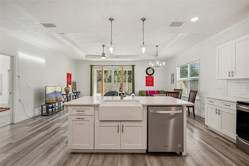 6657 Southwest 15 Place Gainesville, FL 32607 - Photo 6 of 23 a kitchen that has a lot of white cabinets and stainless steel appliances