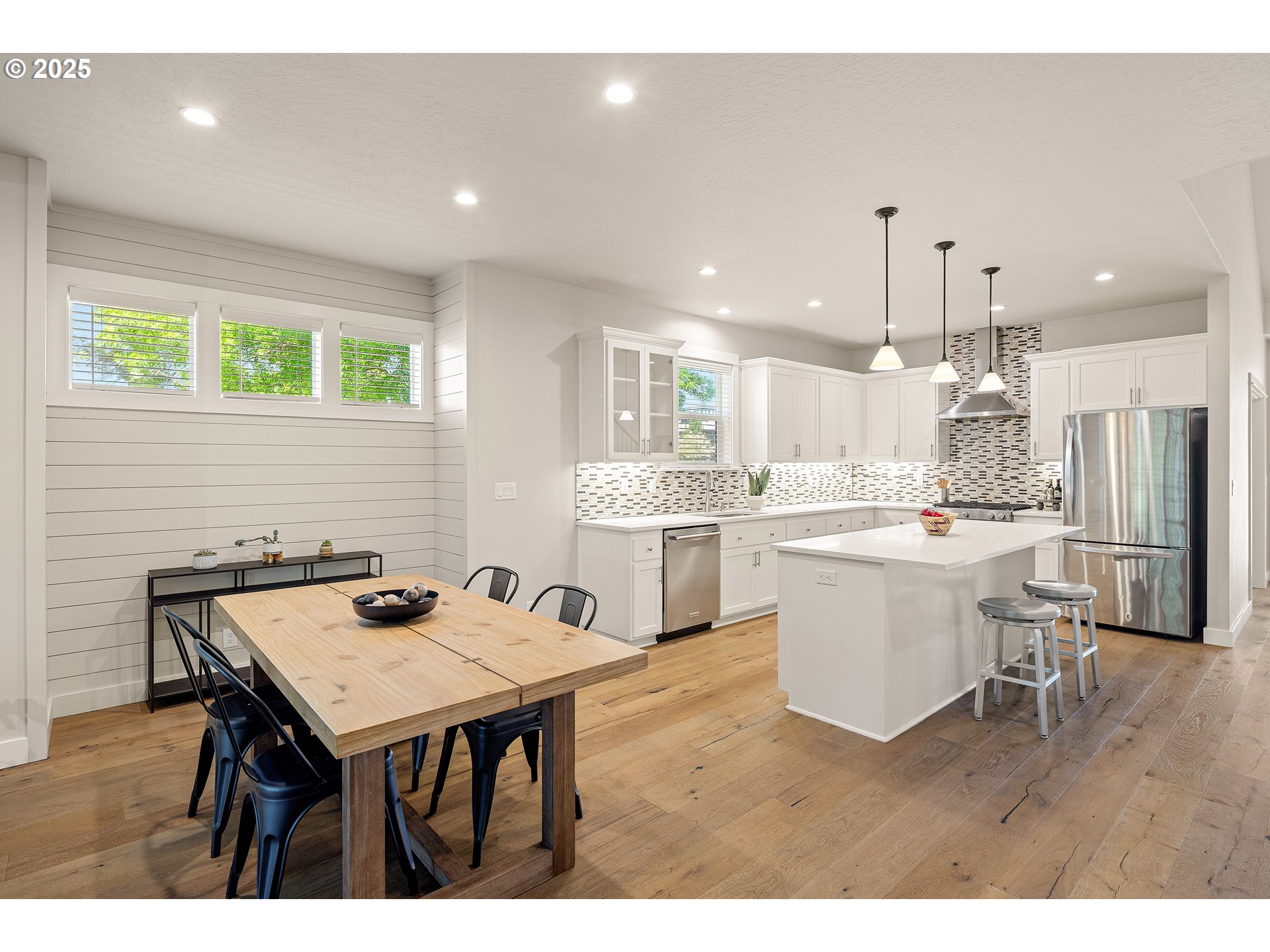 1408 Taylor Street Eugene, OR 97402 - Photo 13 of 43 a open dining room with stainless steel appliances kitchen island a table chairs and a refrigerator