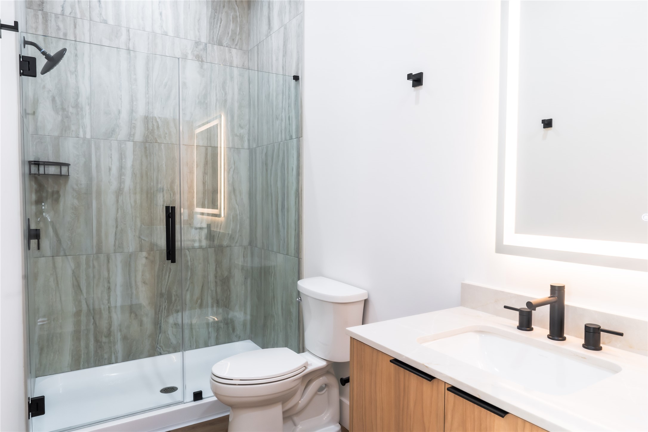 5614 Larkin Street, Unit D Houston, TX 77007 - Photo 12 of 16 a bathroom with a sink a toilet and shower