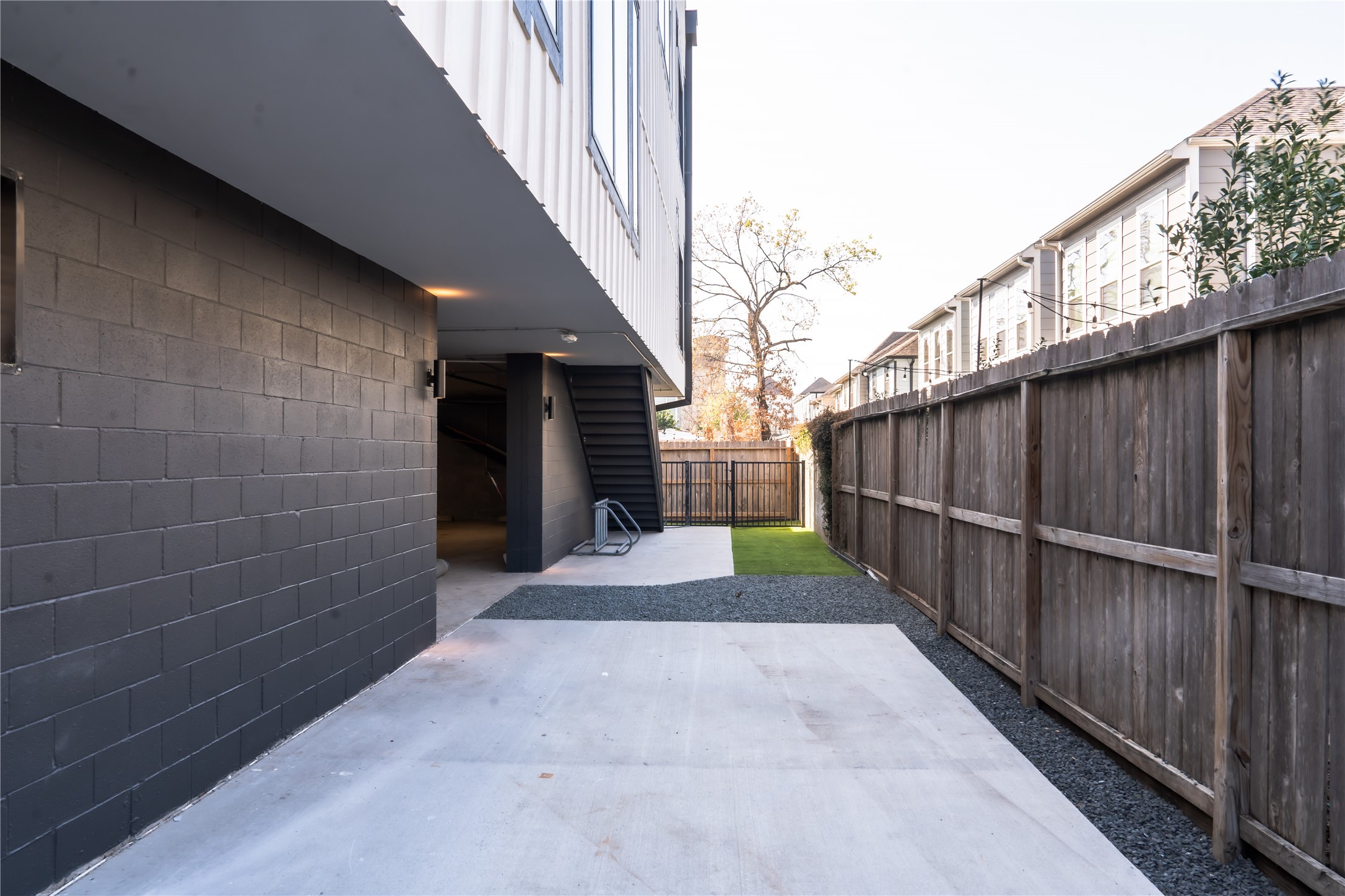 5614 Larkin Street, Unit D Houston, TX 77007 - Photo 14 of 16 a view of a pathway of a building with wooden fence