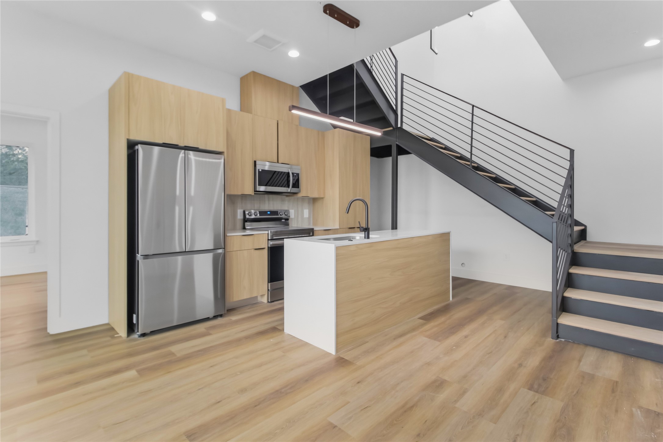 5614 Larkin Street, Unit D Houston, TX 77007 - Photo 2 of 16 a kitchen with stainless steel appliances a refrigerator and a stove top oven