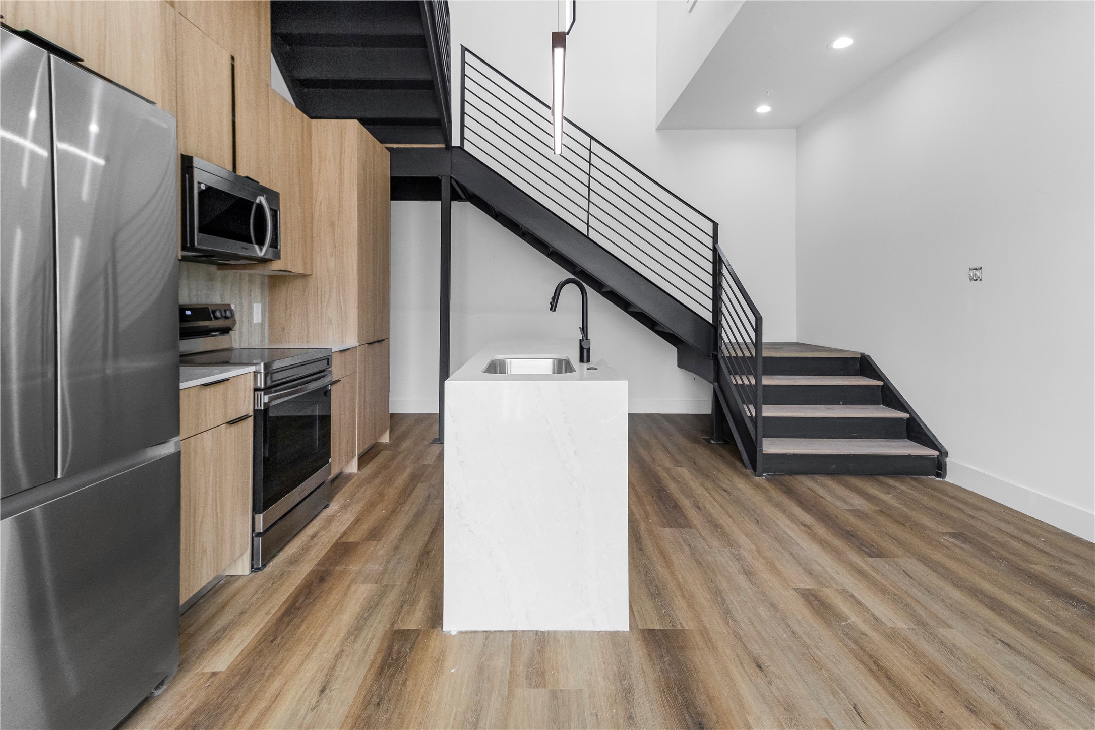 5614 Larkin Street, Unit D Houston, TX 77007 - Photo 5 of 16 a kitchen with stainless steel appliances a refrigerator and a stove top oven