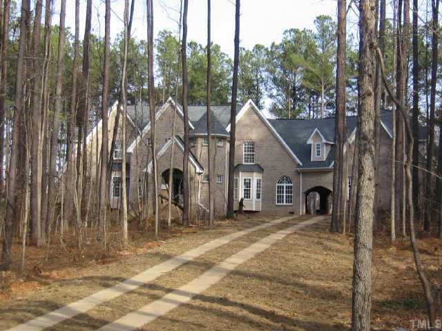 7015 Denlee Road Raleigh, NC 27603 - Photo 4 of 4 a view of a house with backyard and trees