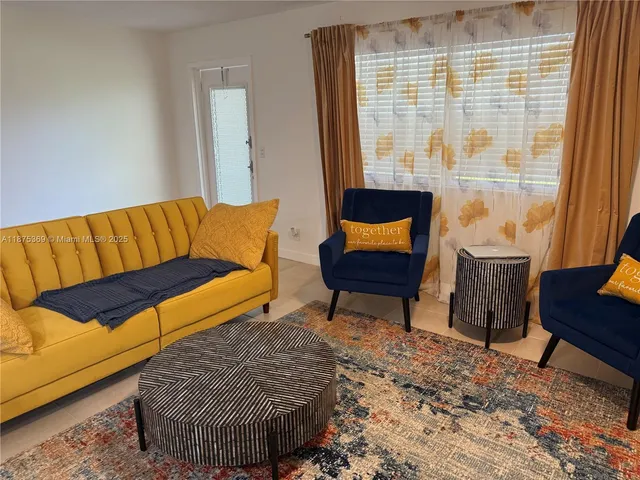 a couch sitting in a room next to a window