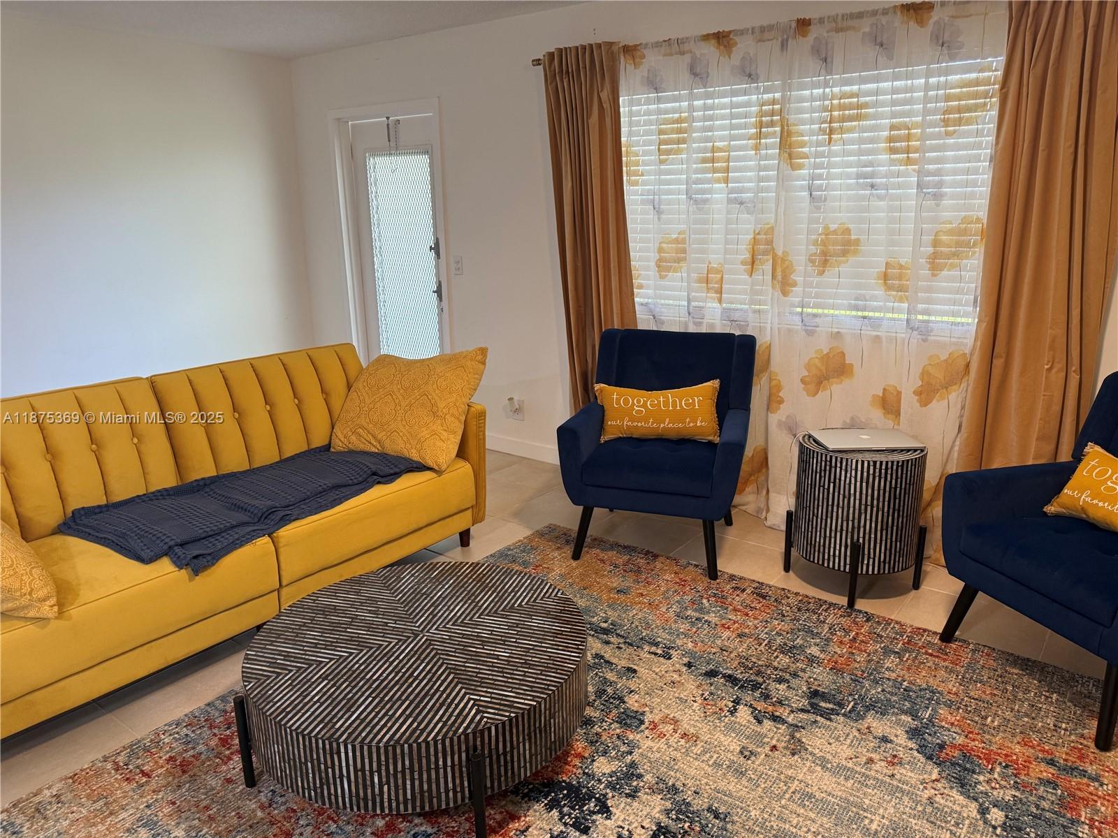 a couch sitting in a room next to a window