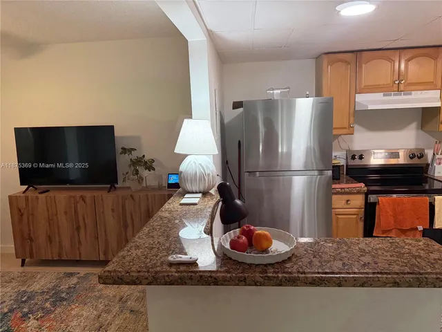 a kitchen with a refrigerator and a microwave