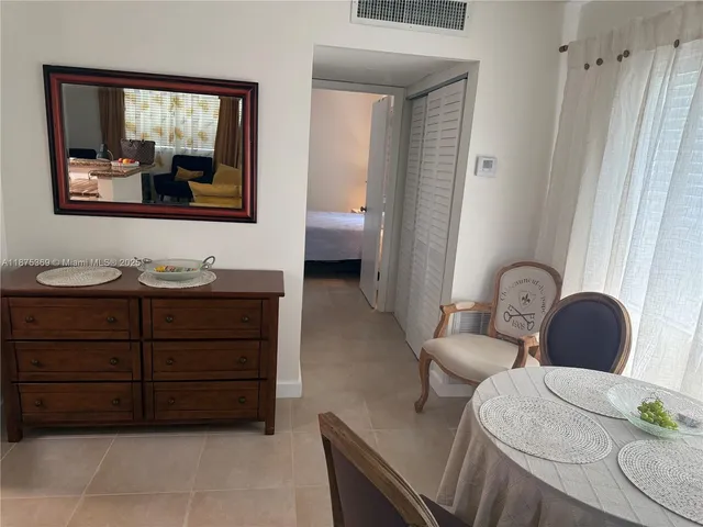 a living room with furniture and a painting on the wall