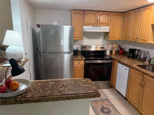 a kitchen with a stove and a refrigerator