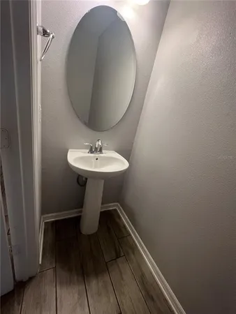 a bathroom with a sink toilet and mirror