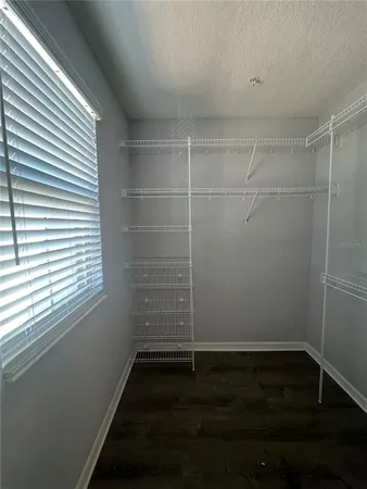 a view of a room with wooden floor and a window