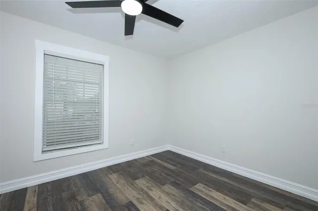 an empty room with wooden floor