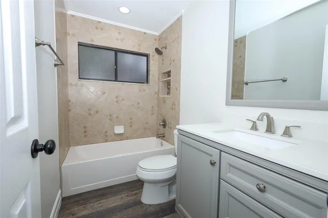 an empty room with a window and ceiling fan