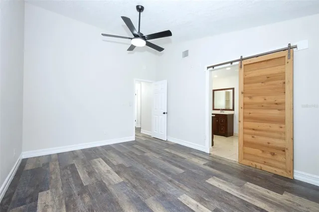 a view of a room with wooden floor closet and windows