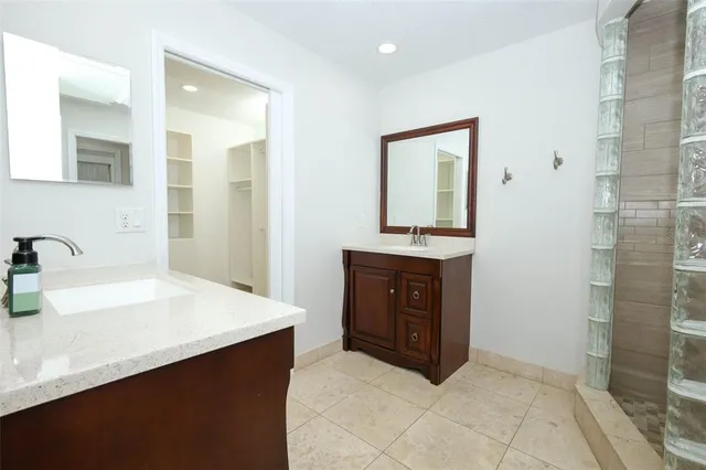 a bathroom with a sink vanity and mirror