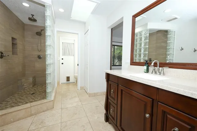 a bathroom with a shower sink and mirror