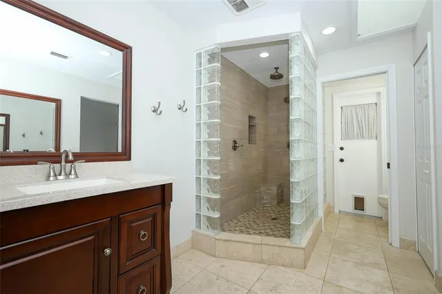 a bathroom with a glass door shower