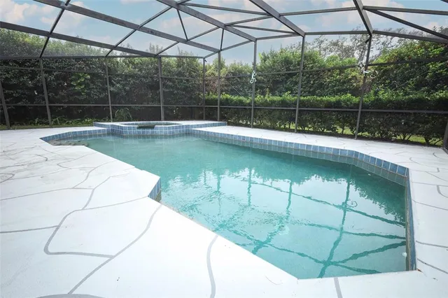 a view of a swimming pool with a yard