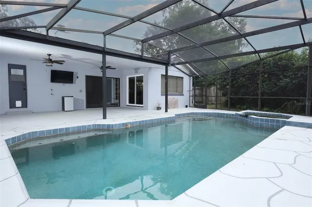 a view of a swimming pool with a yard in the background