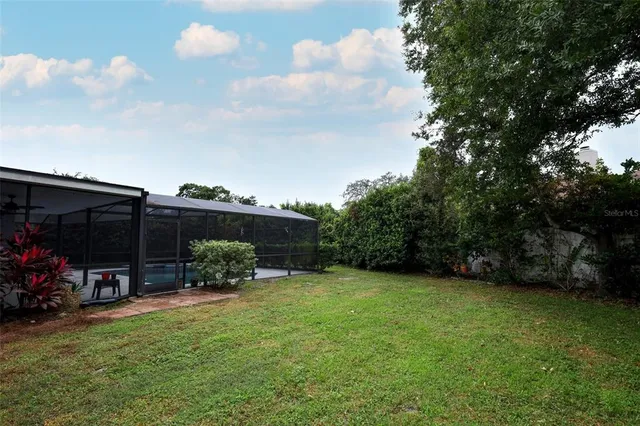 a view of a house with a yard and sitting area