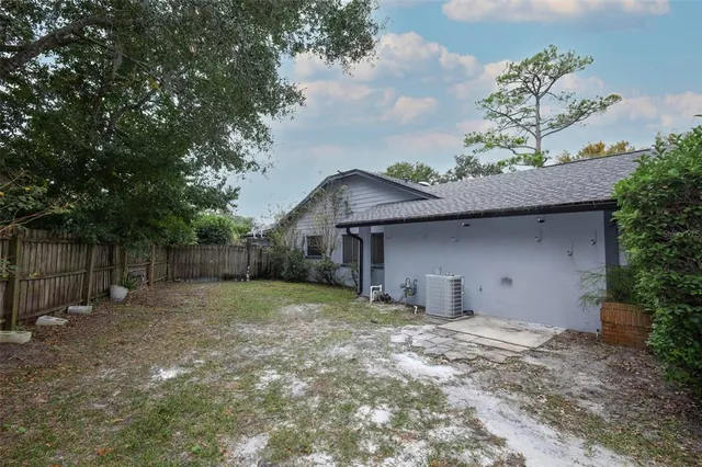 a view of a yard with plants and trees