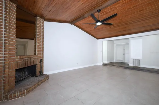 a view of an empty room with a fireplace