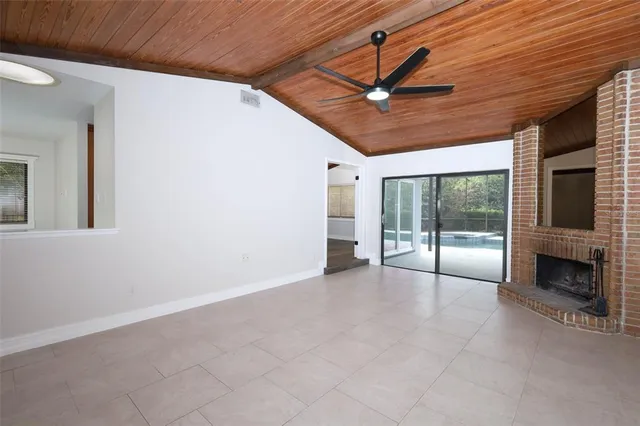 a view of an empty room with a fireplace