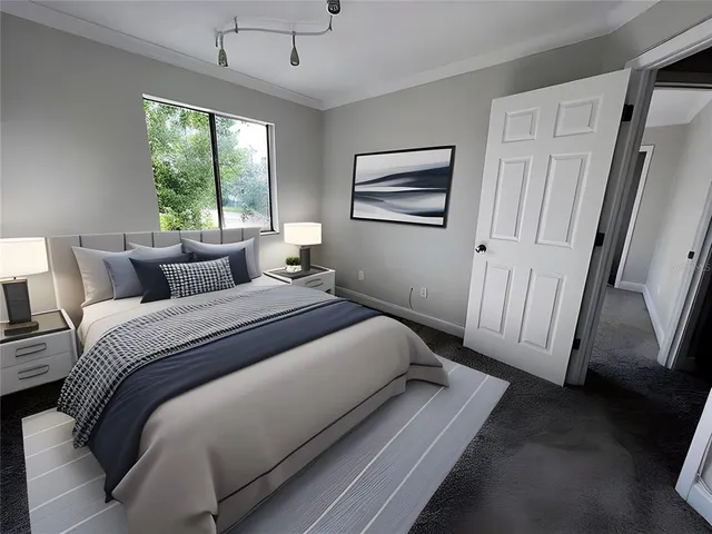 an aerial view of residential houses with outdoor space and trees