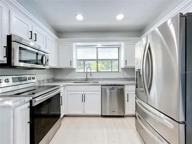 a bathroom with a sink toilet and a mirror