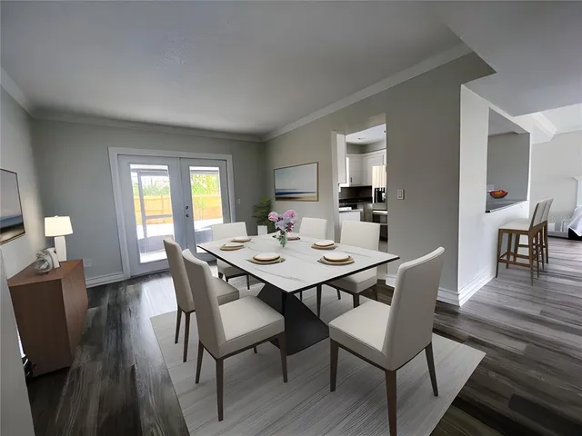 a view of a a dining room with furniture window and wooden floor