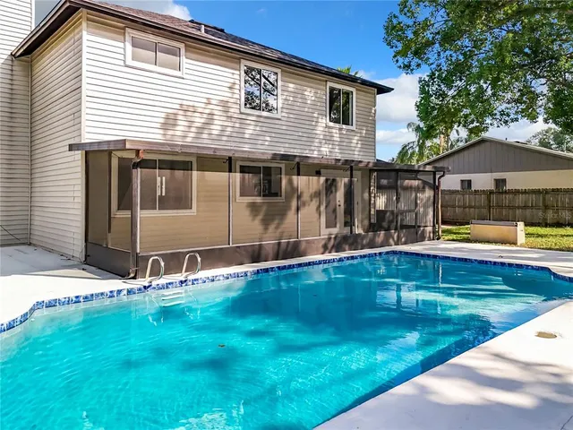 a front view of house with yard and trees around