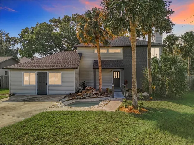 a front view of house with yard and outdoor seating