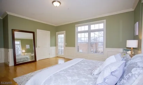 a spacious bedroom with a large bed and a large window