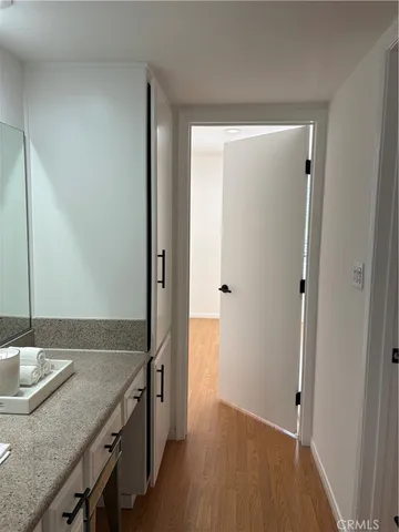 a kitchen with granite countertop a sink and a refrigerator