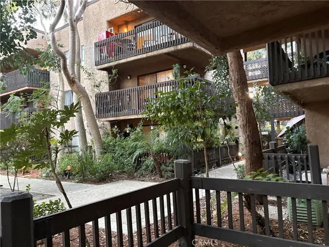 a view of a brick house with large windows